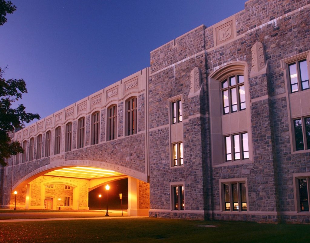 Black and white image of building and bridge built with hokie stone